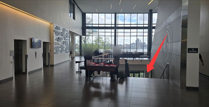 UCC atrium; a red arrow points to the staircase going down