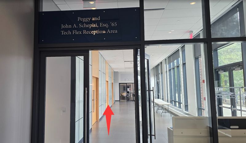 Glass doors under the Tech Flex Reception Area sign; a red arrow points through them